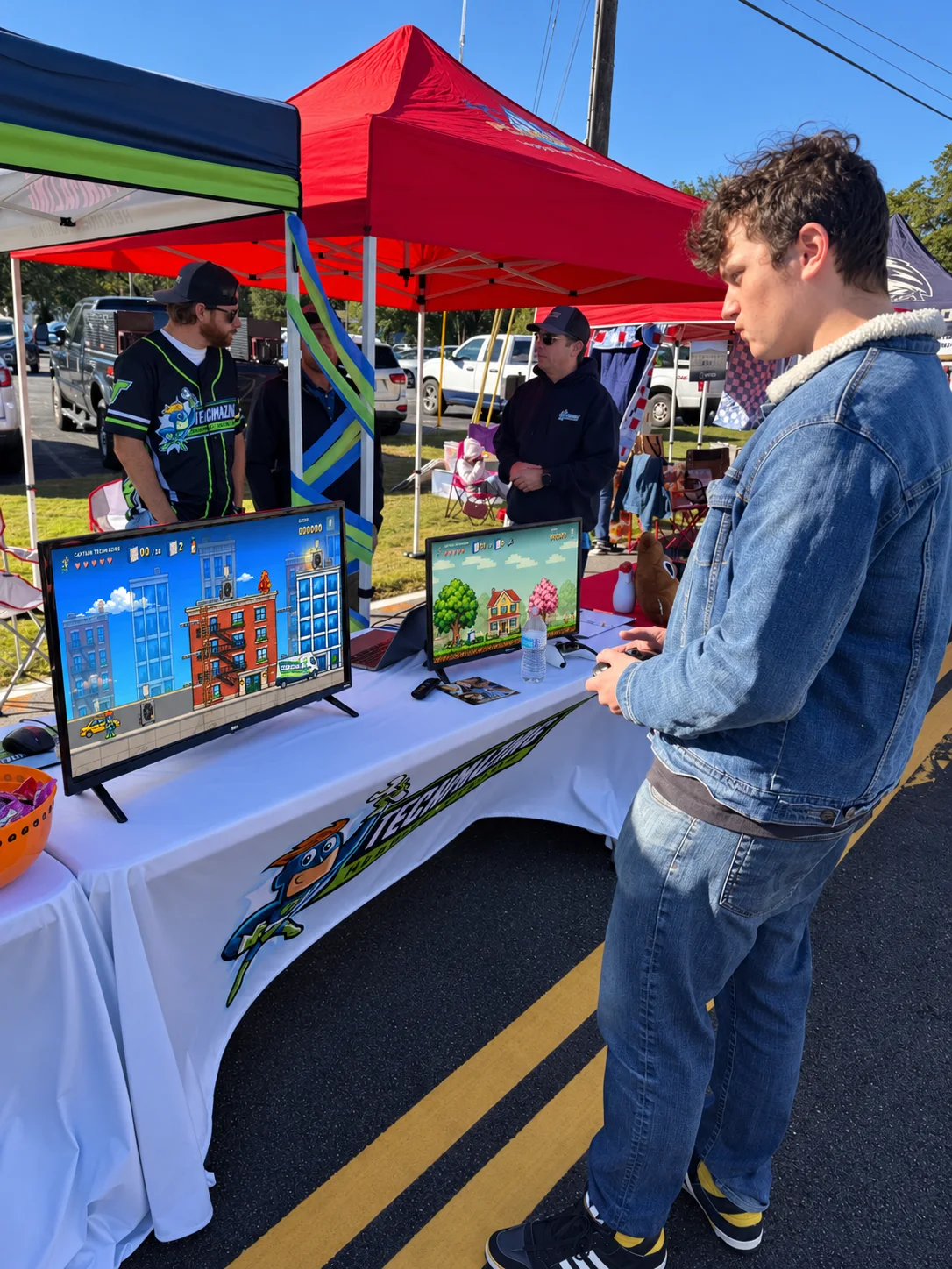 A visitor plays Seasons of Service at the Techmazing booth.